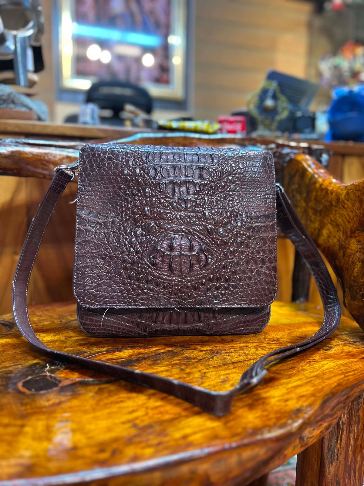 Brown crocodile hornback sling bag with leather strap