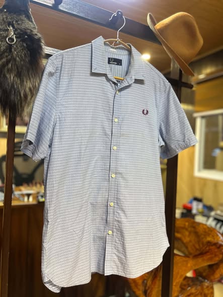 Fred Perry micro-dot short-sleeve shirt on hanger