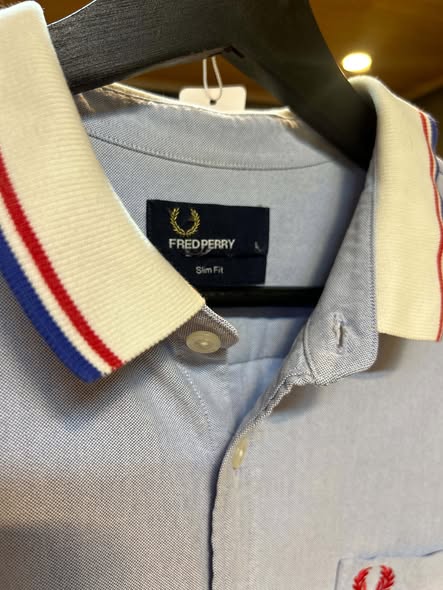 Fred Perry Slim Fit label and striped collar close-up