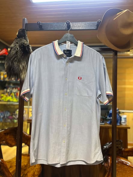 Fred Perry light blue Oxford shirt on hanger