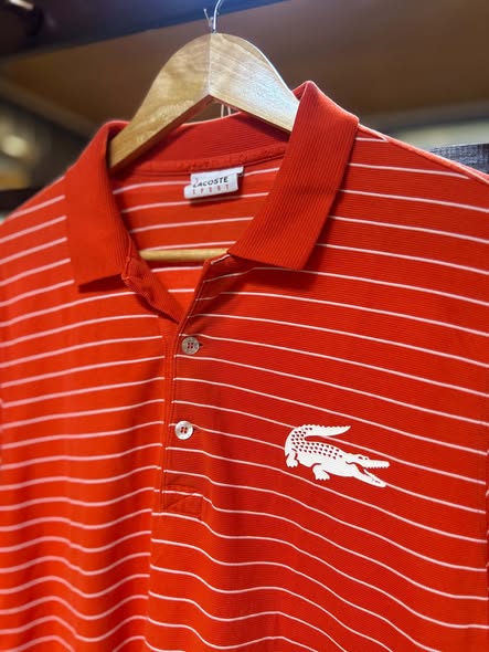 Lacoste Sport red polo with fine white stripes and crocodile logo